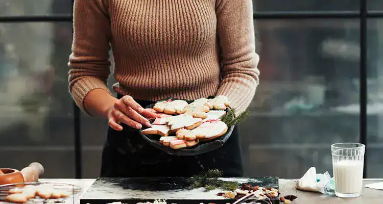 Woman preparing cookies at EbuyerBaker Bakery MarketPlace for a barbecue party.