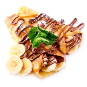 Delicious banana and chocolate crepe with fresh fruit and mint garnish.
