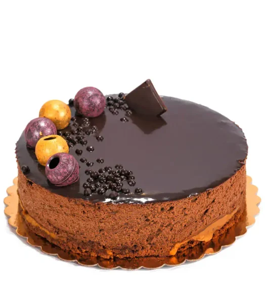 Chocolate cake with berries, chocolate decoration, and glossy glaze.